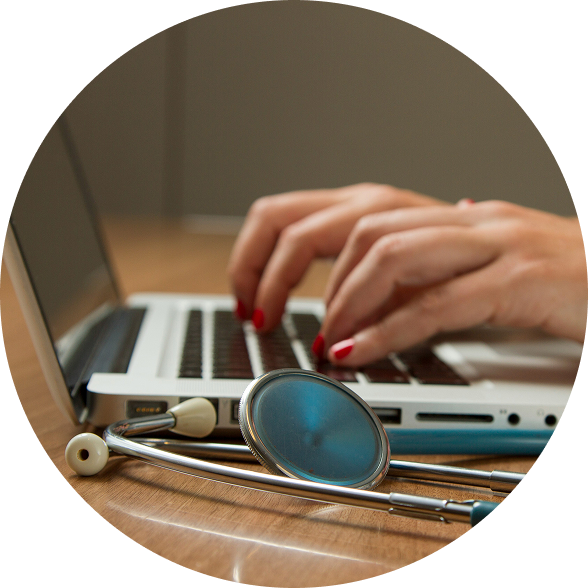 Hands typing on laptop