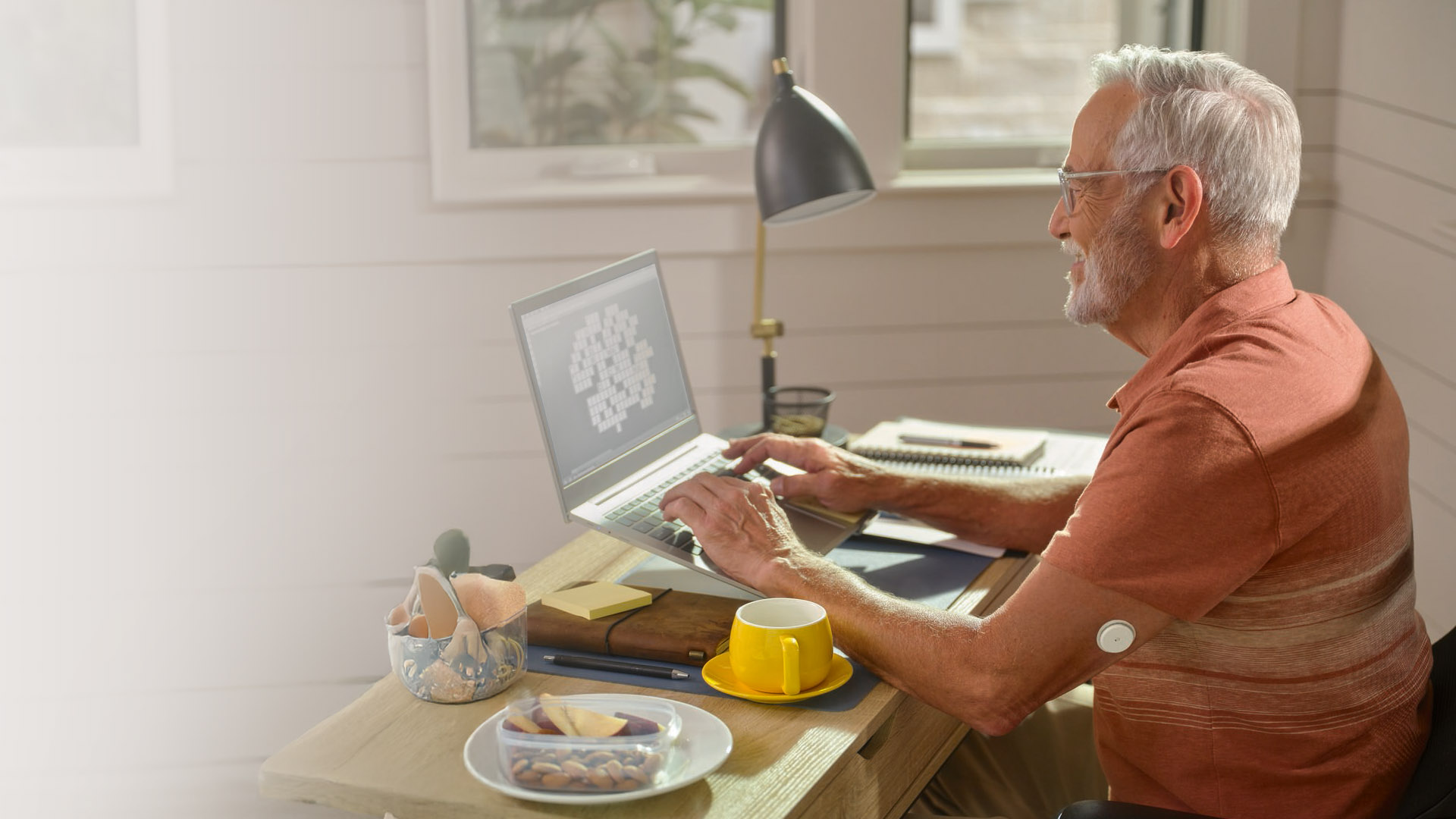 A FreeStyle Libre System user wearing sports wear with her sensor visible user smiling at her phone