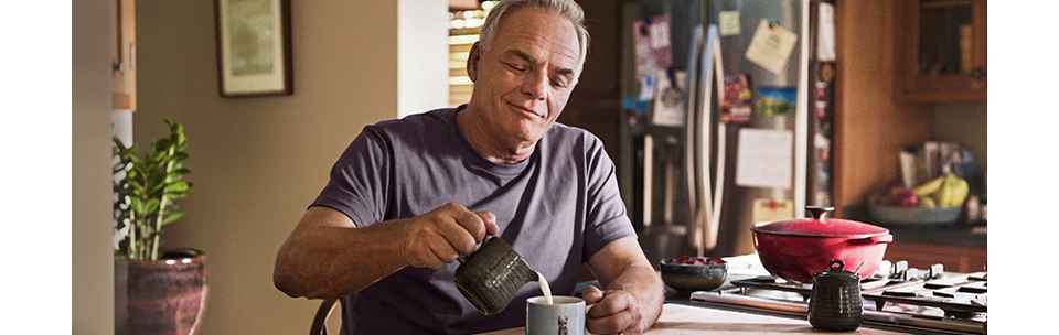 Man wearing FreeStyle Libre 3 Plus sensor in kitchen