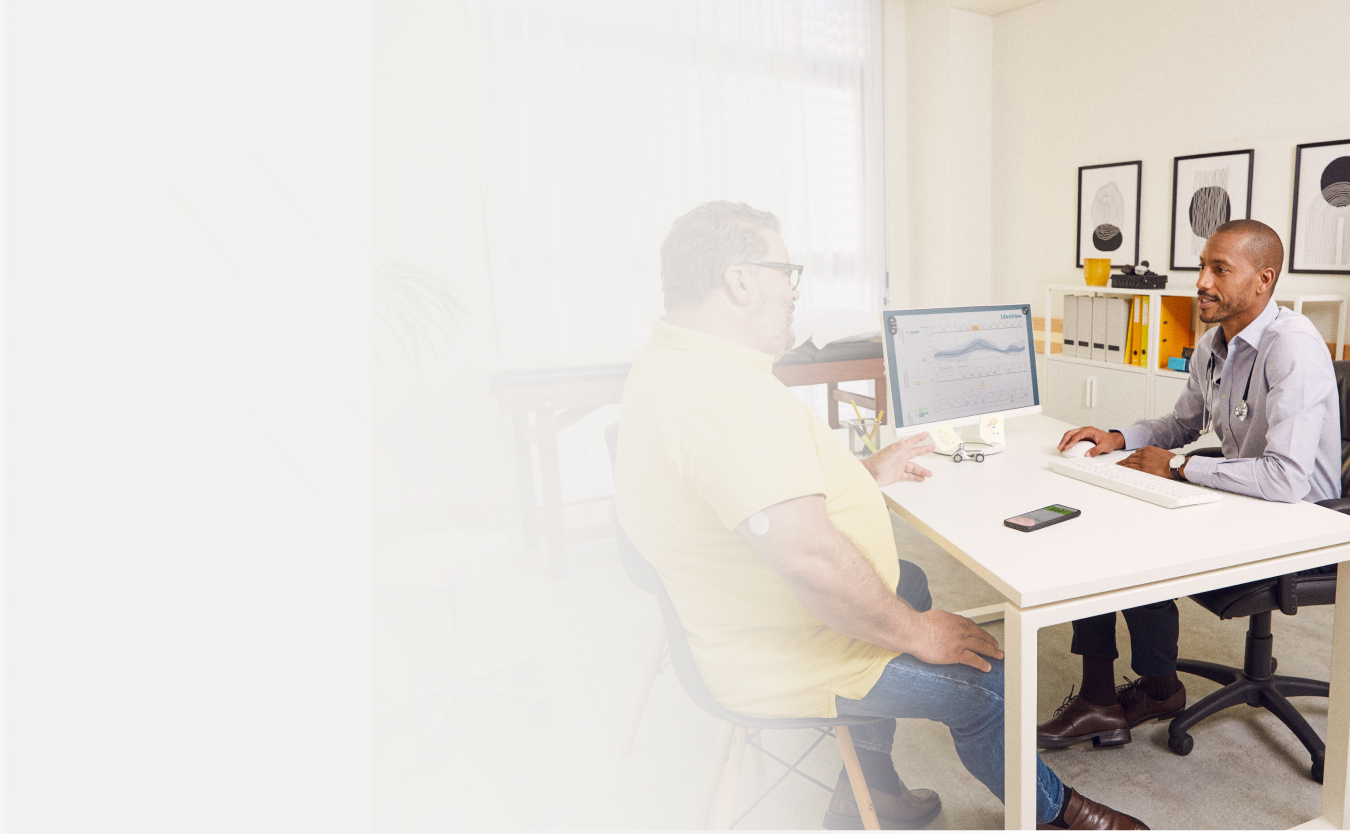 A FreeStyle Libre System Healthcare Professional talking to a patient.