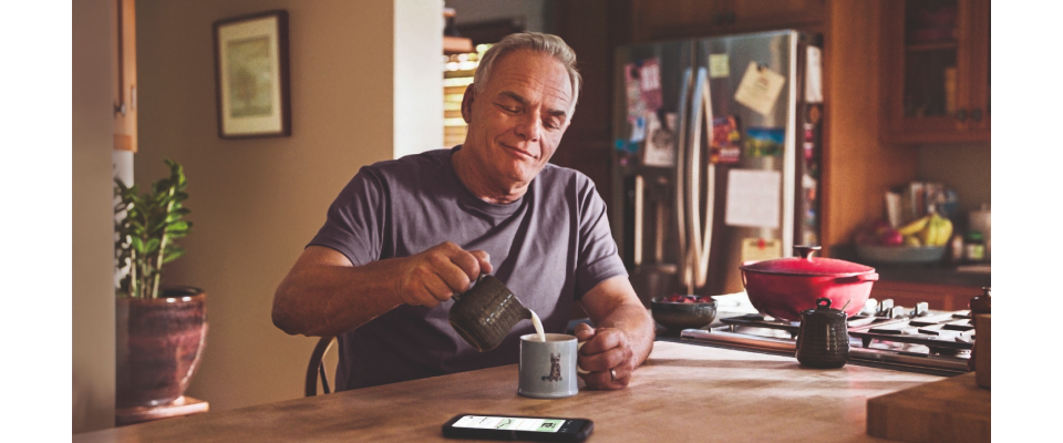 Man wearing FreeStyle Libre 3 Plus sensor in kitchen