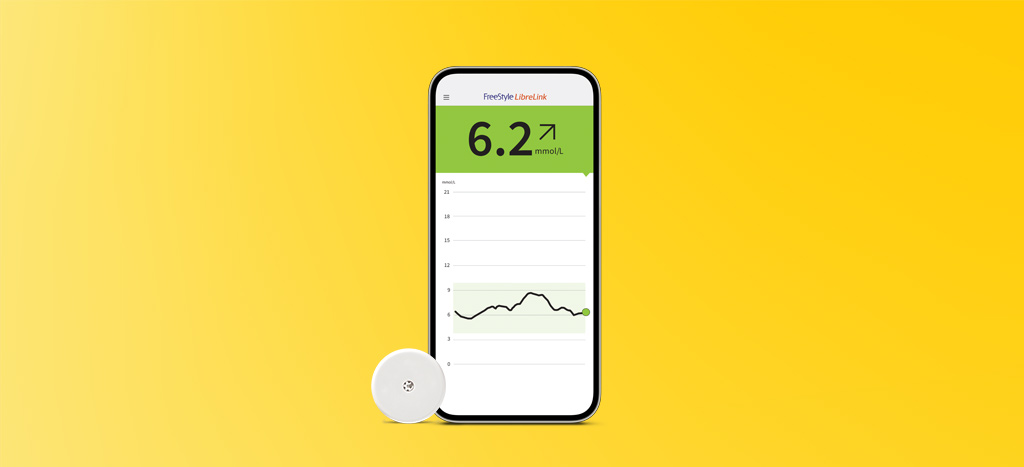 FreeStyle Libre 2 sensor and the FreeStyle LibreLink app shown on a smartphone.