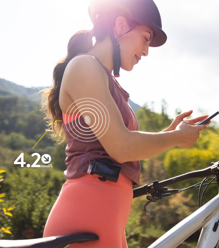 A FreeStyle Libre user scanning a connected insulin pen on her smartphone