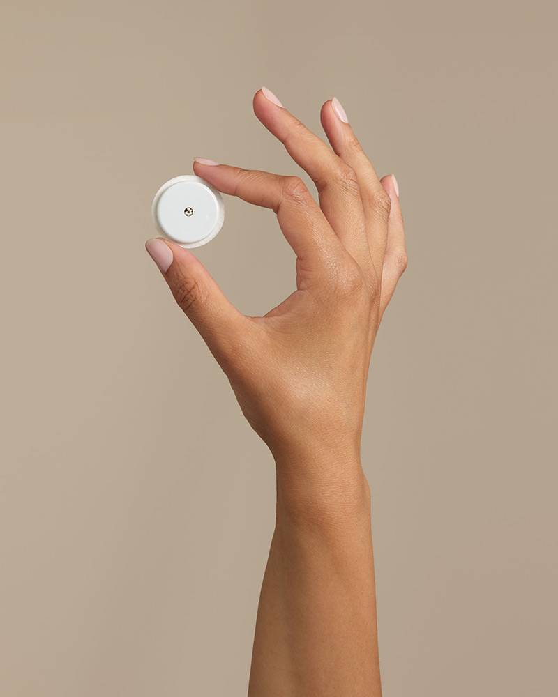 Hand holding FreeStyle Libre sensor