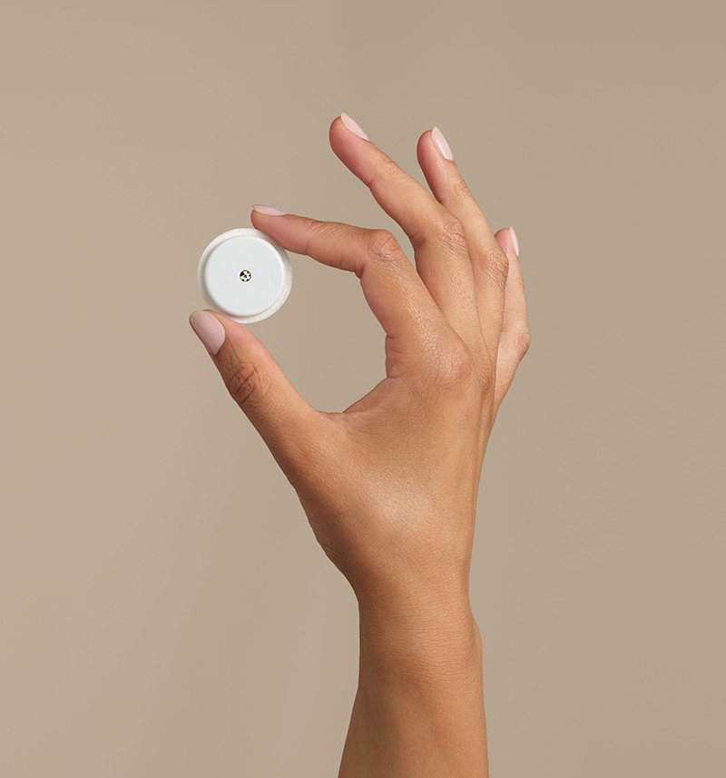 Hand holding FreeStyle Libre sensor