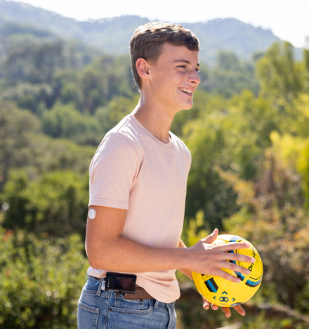  Teen boy with sensor holding a ball